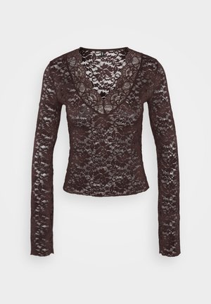 Langermet brun blonde topp med dyp V-hals, blomster mønstre og en tettsittende design. Myk, strukturert stoff med intrikate detaljer.
