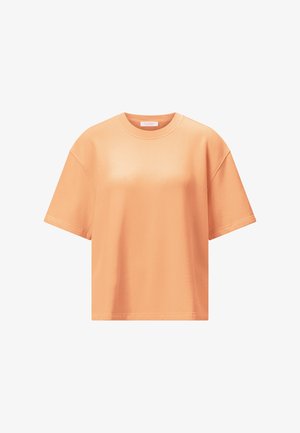 Kratek, ohlapen bombažni T-shirt barve breskve z okroglim izrezom na belem ozadju.