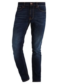 Mörkblå denimjeans med slim fit, med femfickorsdesign, orange sömmar och en klassisk knappstängning.