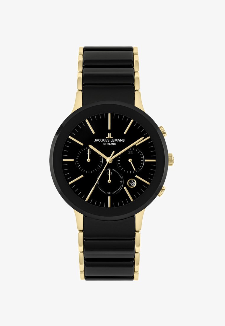 Musta keraaminen kello pyöreällä kellotaululla, kullanvärisillä yksityiskohdilla, kolmella apunäytöllä ja päivämääräikkunalla. Kiinteä musta ranneke, jossa kullanvärisiä lenkkejä.