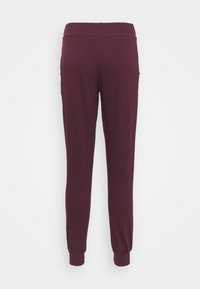 Pantalones jogger burdeos con tejido suave, cintura elástica y puños ajustados. Incluye bolsillos laterales para mayor utilidad.