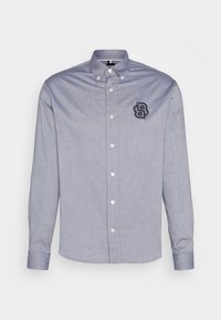 Ljusblå skjorta med knappar i bomullsblandning, med krage, långa ärmar och broderad logotyp på bröstet.