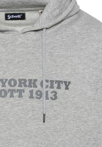 Felpa con cappuccio grigia in morbido misto cotone, con una grande stampa grafica in grigio scuro: "NEW YORK CITY SCHOTT 1913." Include coulisse.