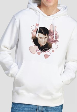 White hoodie with a black and white portrait of a man surrounded by pink hearts and the text "Love Me Tender" and "Elvis Presley."