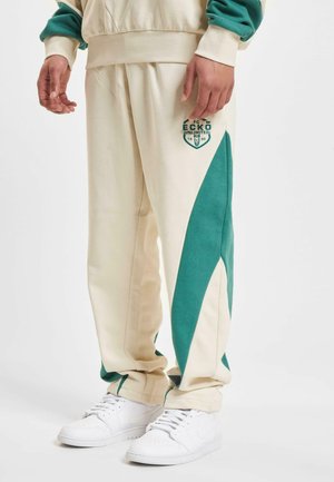 Beige sweatpants med grønne sidelister, der har et Ecko Unlimited-logo. Fremstillet af blødt bomuldsblandingsmateriale, designet til komfort og afslappet brug.
