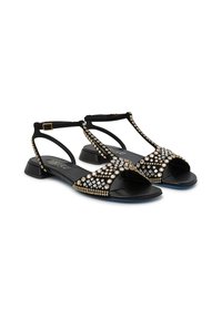 Sandali neri con design a T-straps, decorati con numerosi strass, dettagli dorati e tacco a blocco. Texture liscia e punta aperta.