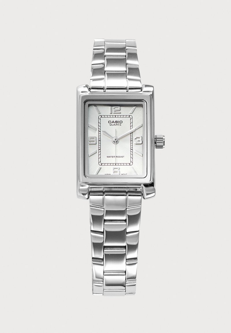 Montre-bracelet Casio quartz argentée avec cadran rectangulaire, bracelet à maillons en métal, chiffres aux positions 12, 3, 6 et 9, et mention résistante à l'eau.
