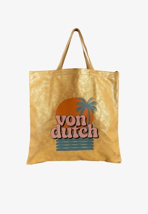 Bolsa tote reutilizable dorada con asas cortas, con gráfico de puesta de sol, palmera, olas y texto "von dutch" en el frente.