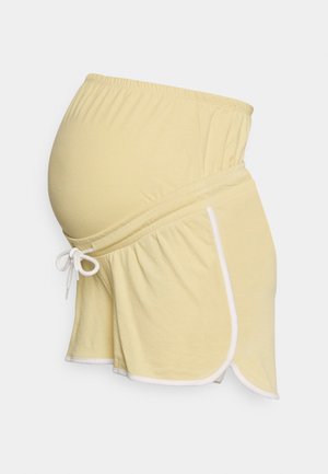 Bermudas amarelas de maternidade com um cós elástico, bolsos laterais e bainha branca. Feitas de um tecido macio, foram desenhadas para conforto durante a gravidez.