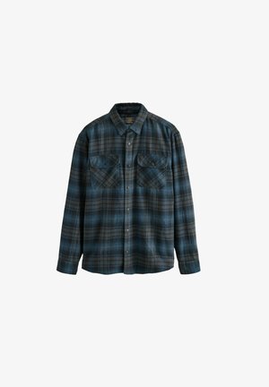 Flannel skjorte med blå og sort ternet mønster, knaplukning foran, to brystlommer, lange ærmer og krave der kan foldes ned.