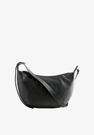 Black leather shoulder bag with a textured surface, curved shape, adjustable strap, and gold-tone hardware accents.