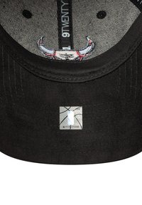 Schwarze Kappe mit flachem Schild, mit einer grauen Unterseite. Im Inneren befindet sich ein Grafikdesign mit Hörnern und einem blauen NBA-Logo-Tag.