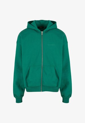 Hanorac verde cu fermoar, cu o buzunar frontal spațios, manșete și tiv cu nervuri, fabricat dintr-un material moale. Prezință un logo subtil pe piept.