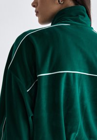 Lacoste Sweater met rits - fluorine foncé/white