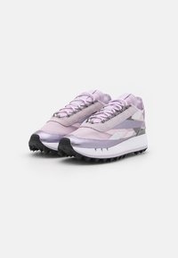 Shoes in light purple with texture variations, featuring gray accents and a thick white sole. Black, serrated rubber outsole for traction.