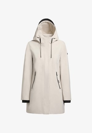 Veste imperméable beige clair avec capuche, accents noirs, fermeture éclair à l'avant et deux poches latérales zippées. Texture lisse, coupe décontractée.