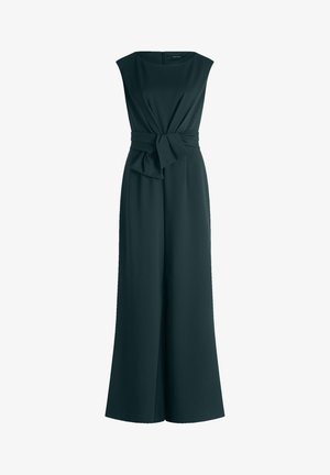 Tummanvihreä haalari, jossa on hihaton muotoilu, leveät lahkeet ja sidottu vyötäröyksityiskohta. Sileä kangas ilman näkyviä kuvioita.