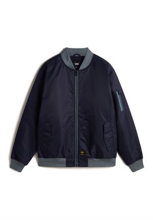 Navy blue bomber jacket with a front zipper, side pockets, and a pocket on the left sleeve. Gray ribbed cuffs and collar. Smooth texture.