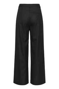 Mustad laia säärega püksid, millel on sile pind, vöökoht ja tagatasku. Kangas tundub struktureeritud ja hästi istuv.