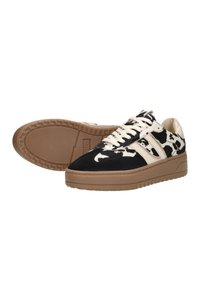 Black and white patterned sneakers with suede upper, beige lace accents, and a brown rubber sole featuring a textured grip design.