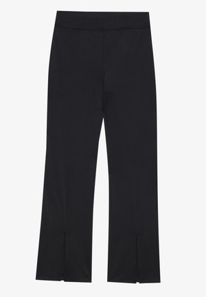 Svart leggings laget av elastisk stoff med en glatt tekstur. Har en tettsittende midjebånd og sideåpninger på kanten for ekstra detaljer.