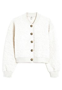 Kermankollane lühike bomberjakk, millel on tekstuuriga kangas, soonikkoes randmed ja äär, ning kuus pruuni nööpi esiküljel.