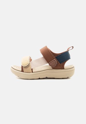 Beige, brown, and navy open-toe sandal with adjustable straps and cushioned sole, designed for casual wear.