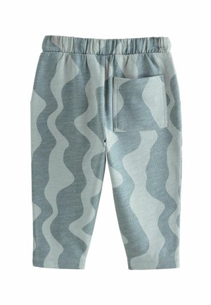 Pantalons bleu clair avec un motif ondulé déclinant en différentes nuances, fabriqués dans un tissu doux. Dotés d'une taille élastique et d'une poche latérale.