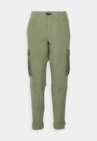 Fleece cargo pants in olive green with a textured surface, elastic waistband, and side pockets featuring contrasting fabric.