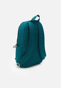 Teal backpack featuring padded sections, adjustable straps, and a side pocket with zipper closure. Smooth fabric texture, streamlined design.