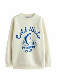 Sweat-shirt couleur crème avec des manches raglan, orné d'un graphique de poisson bleu et du texte "Cold Water Swimmers Club" en lettres grasses.