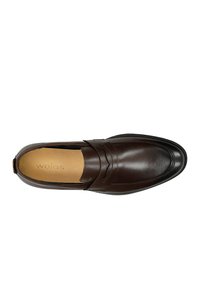 Brown leather slip-on shoe with a smooth finish, featuring a decorative strap across the instep and a round toe design. "wojas" printed inside.