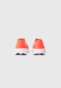 Bright coral running shoes with a lightweight mesh upper, padded collar, and contrasting white midsole and black outsole. Simple star accent.