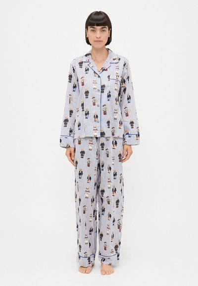 Stripet blå og hvid pyjamas sæt med tegneseriefigurer, lange ærmer og løstsiddende bukser med knaplukning og lomme.