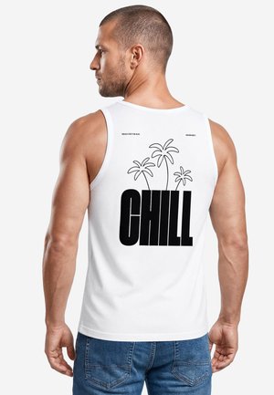 Muscular man with short hair wears a white sleeveless shirt with black palm trees and the word "CHILL" in bold on the back.