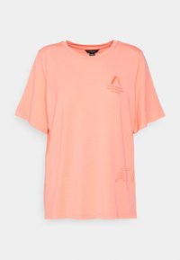 T-shirt de manga curta, com decote redondo, na cor coral brilhante. Fabricado em tecido suave, com uma pequena gráfica e texto na parte da frente e um detalhe em relevo na bainha.