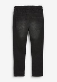 Mustad teksad elastse vöökohaga, kaks tagumist taskut jäägidaga. Sile denimpind, kitsenev jalgade lõige.
