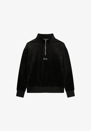 Black fleece pullover with high collar, half-zip front, and embroidered logo. Ribbed cuffs and hem, soft texture, relaxed fit.