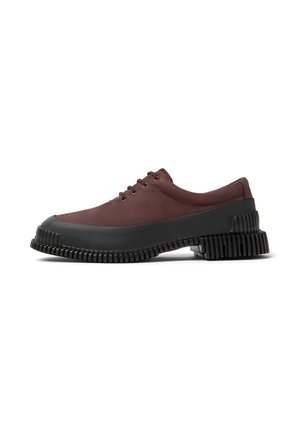 Maroon lace-up shoes with a thick black rubber sole featuring a ridged design. Side profile shows smooth upper texture and sturdy construction.