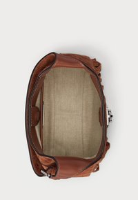 Brown leather and suede handbag, featuring a lined interior with a herringbone pattern and a metallic clasp closure.