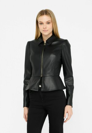Black leather jacket with a peplum waist, zip closure, and collar. Features tailored fit and smooth texture, paired with black pants.