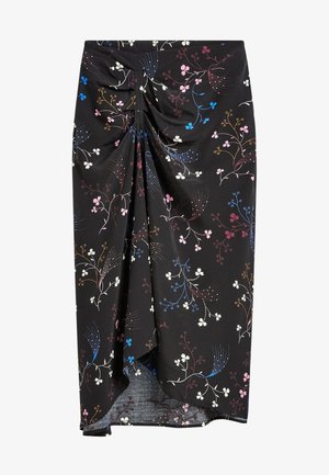 Falda midi negra con nudo retorcido en la parte delantera, con un patrón multicolor de flores y ramas en tonos rosa, azul, blanco y marrón.