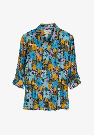 Ziedu krekls ar pogām, uz kura ir zilu, dzeltenu un purpura ziedu kombinācija uz tumša fona. Izgatavots no viegla auduma ar sarullētām piedurknēm.