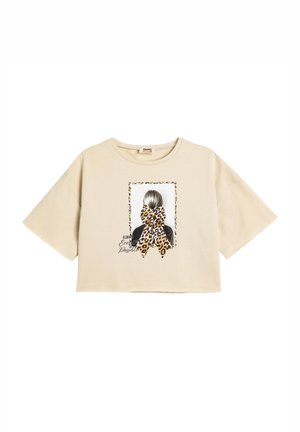 Beige cropped t-shirt lavet af bomuld, med et grafisk tryk af en piges frisure med en leopardmønstret sløjfe og tekst accenter.