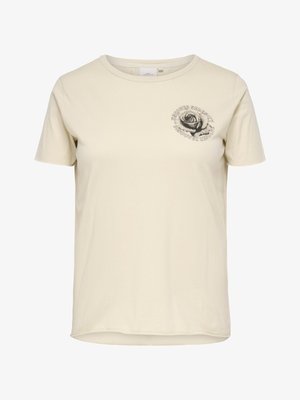 Bézs rövid ujjú póló kerek nyakkal, bal mellrészen kis fekete rózsa grafikával, amelyet az "Uncover Serenity Discover Resolve" felirat vesz körül.