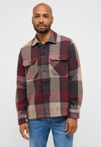 Kariertes Flanellhemd in Rottönen, Schwarz und Beige. Mit zwei Brusttaschen, Knopfleiste und klassischem Kragen. Strukturierte Webart.