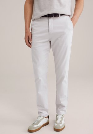 Light gray trousers with a smooth texture, featuring side pockets and a straight cut. Paired with white and gray sneakers on a neutral background.