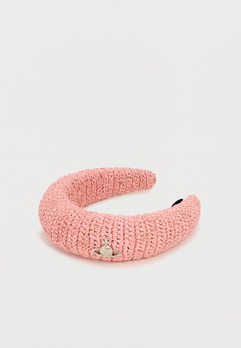 Ροζ υφασμάτινη κορδέλα για τα μαλλιά με ένα μικρό ασημένιο έμβλημα σε σχήμα σφαίρας στη μέση, πάνω σε λευκό απλό φόντο.