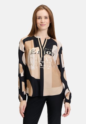 Long-sleeve blouse in black, beige, and cream with abstract shapes and a metallic print. Features a V-neck and elasticized cuffs.