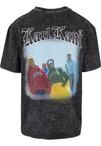 Black, oversized t-shirt featuring a graphic print of four figures wearing colorful hoodies, with "Karl Kani" text above.